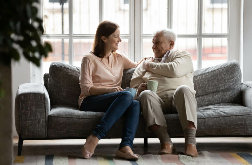 a woman speaks to a senior man in memory care