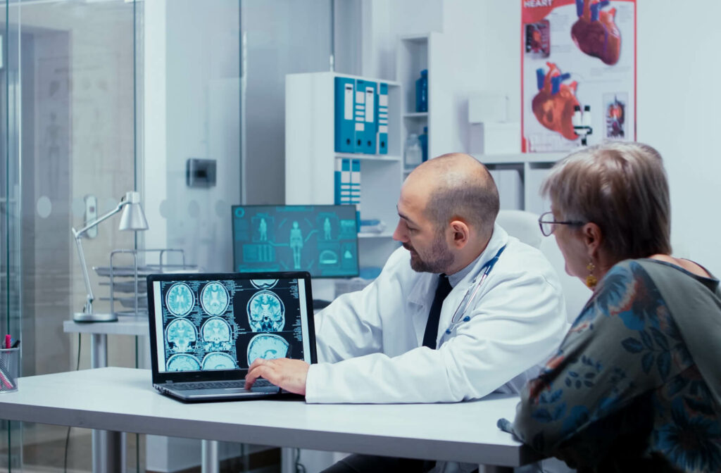 A doctor showing the a CT scan of a brain to his patient.